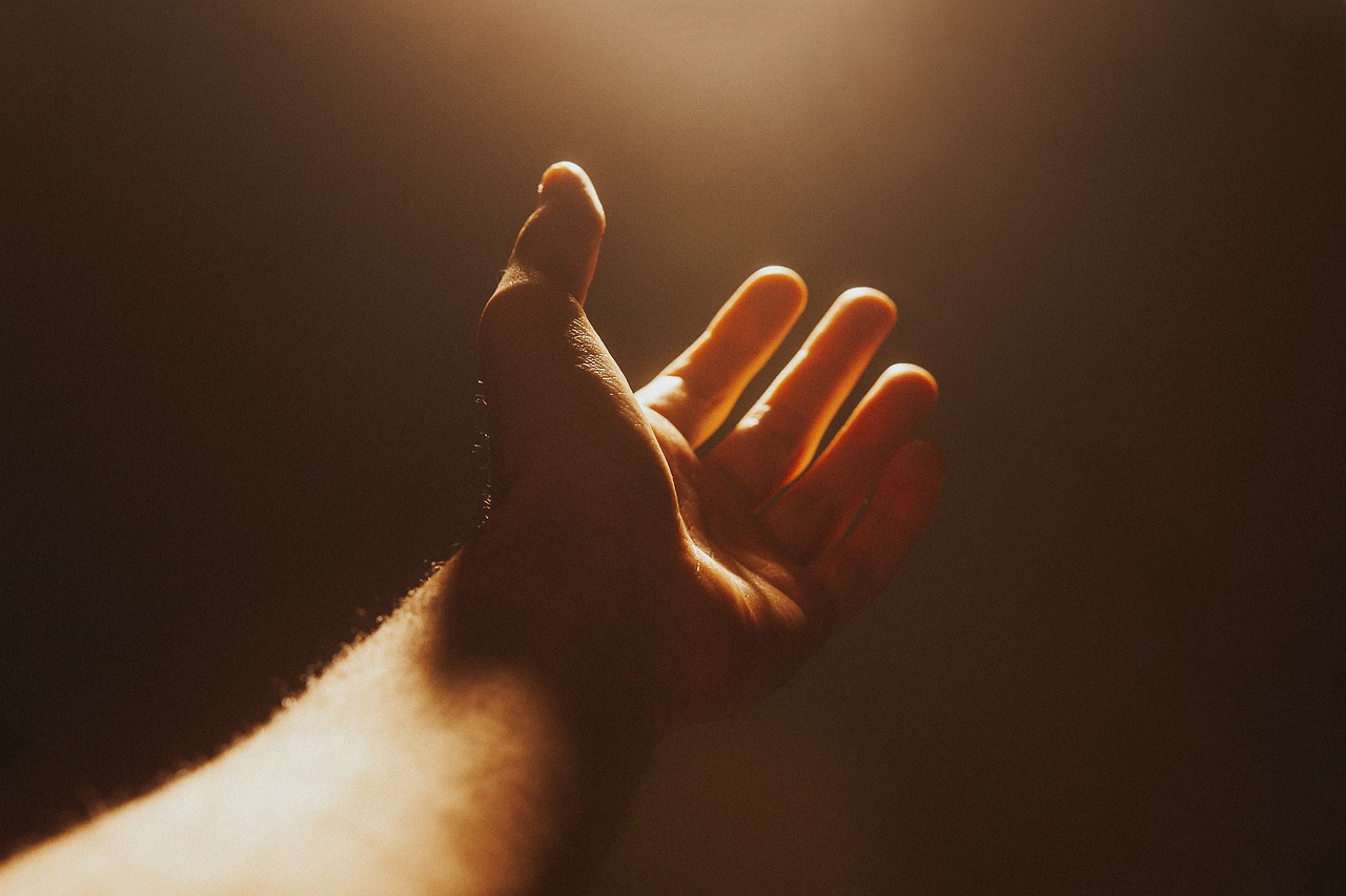Hand reaching into light beam - Hannah Young Life Coaching there must be more to life passion and purpose